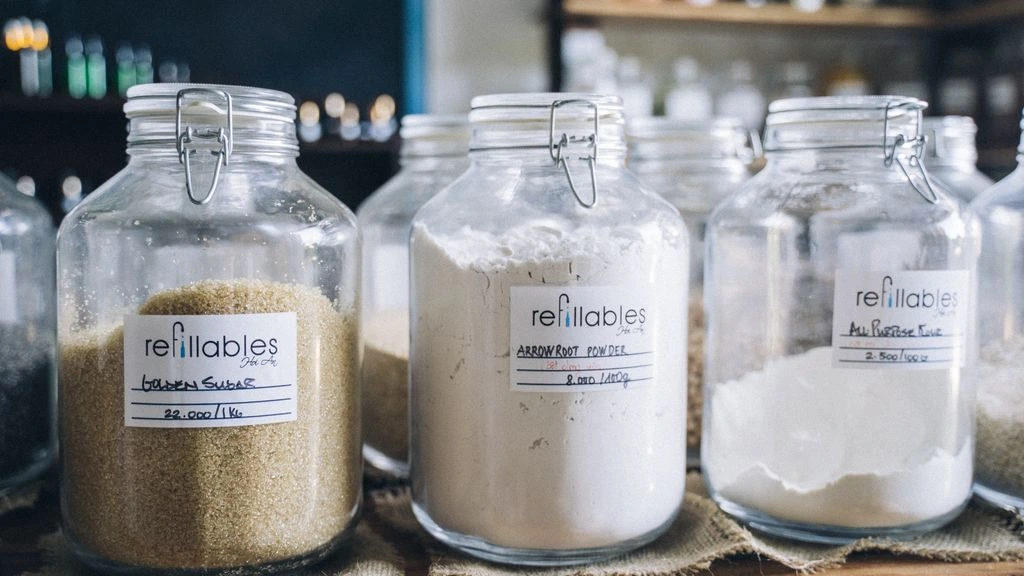 Close-up still life of refillable amber apothecary bottles and dried botanicals.